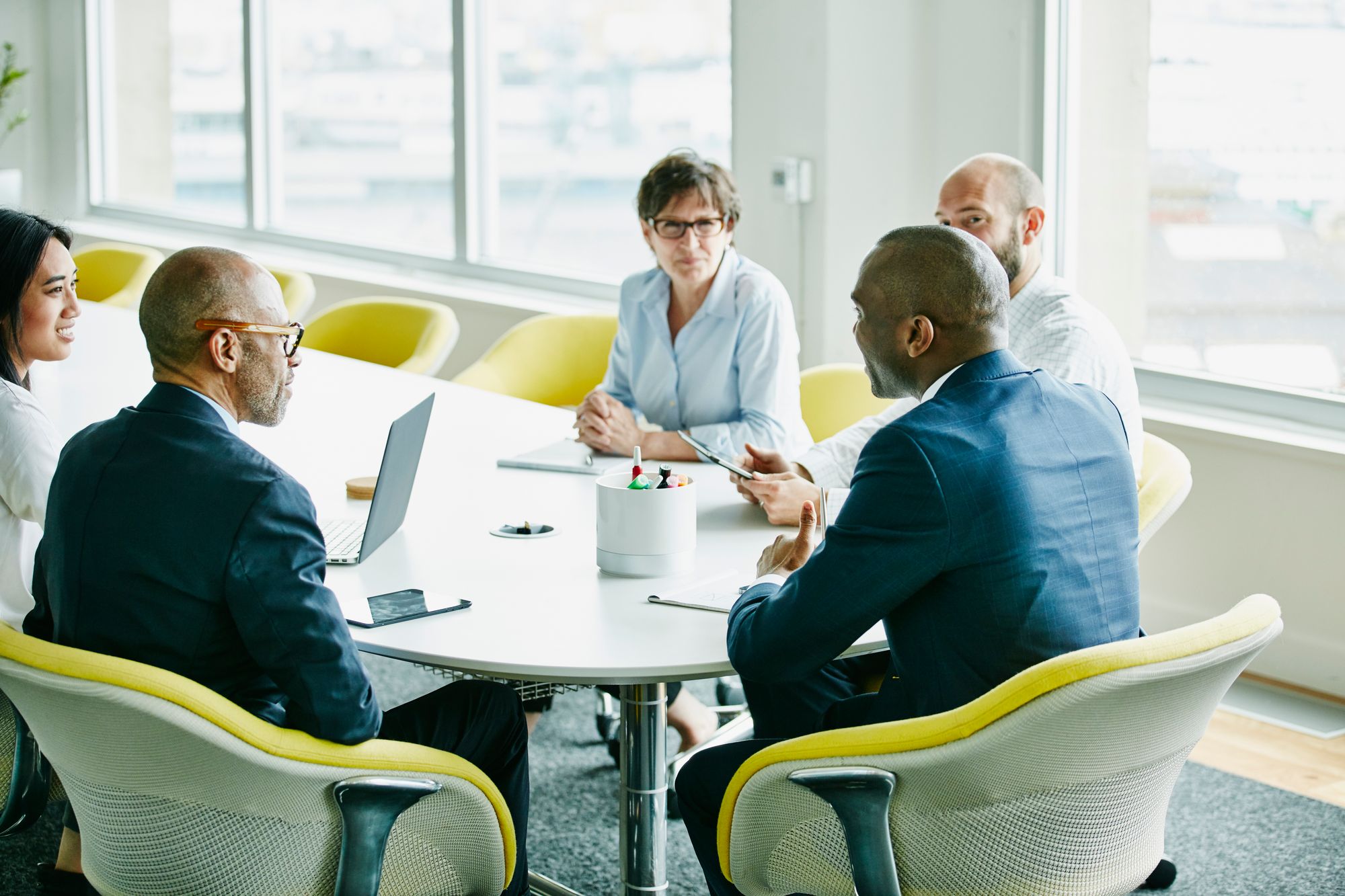 Team of executives sitting at a conference table