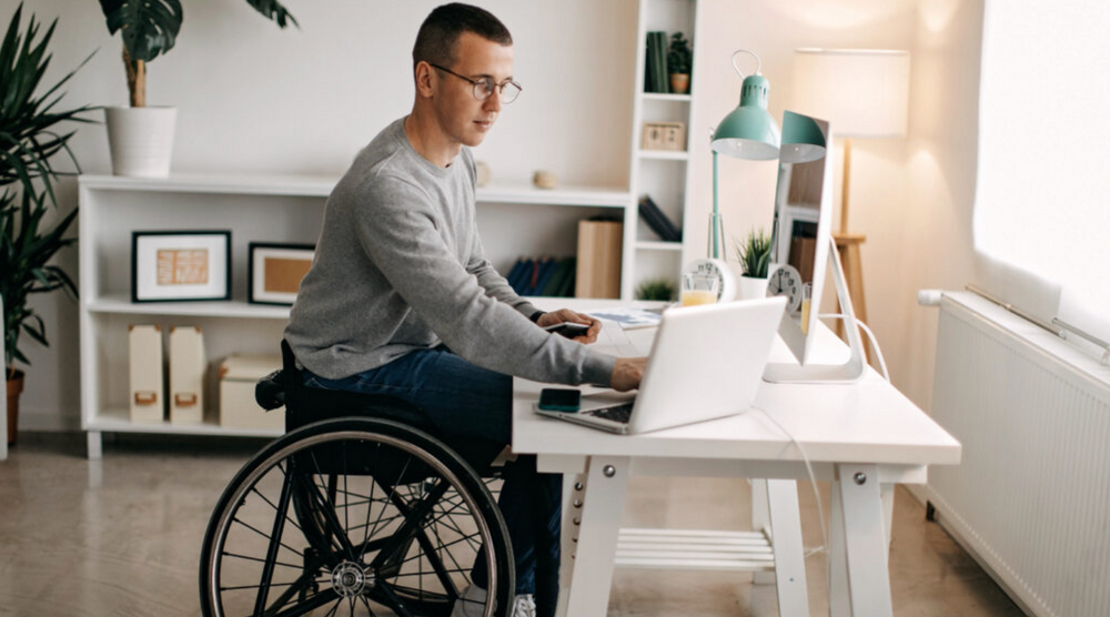 Man using a wheelchair at a desk