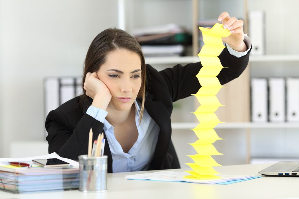 Bored woman playing with sticky notes