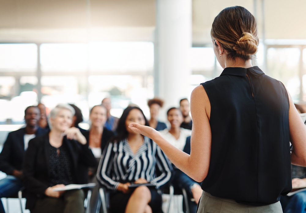 Woman in front of a diverse group leading a meeting