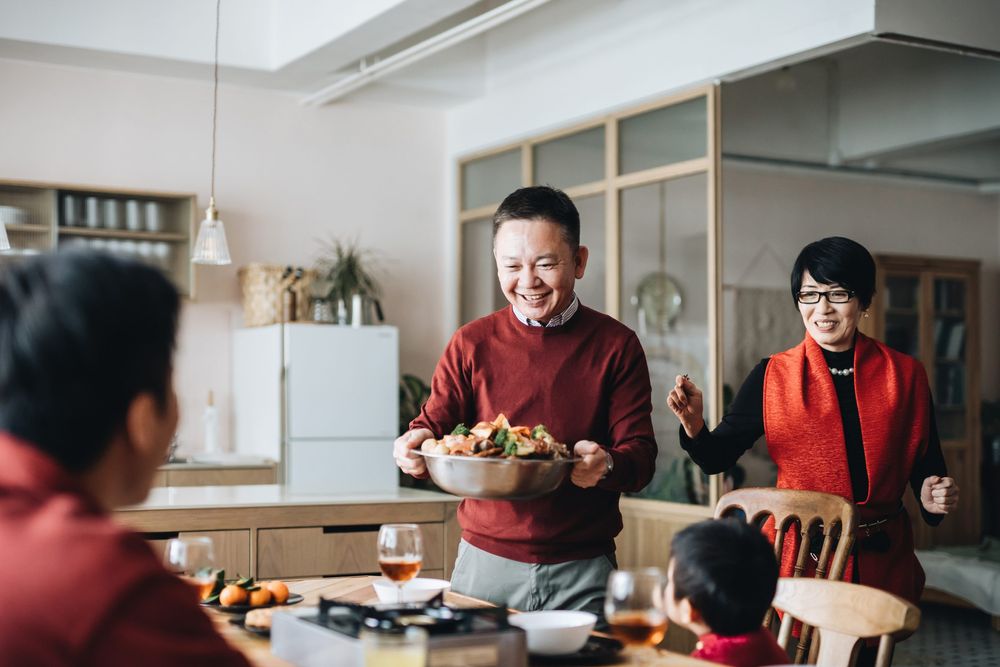 Three generations of joyful Asian family celebrating Chinese New Year