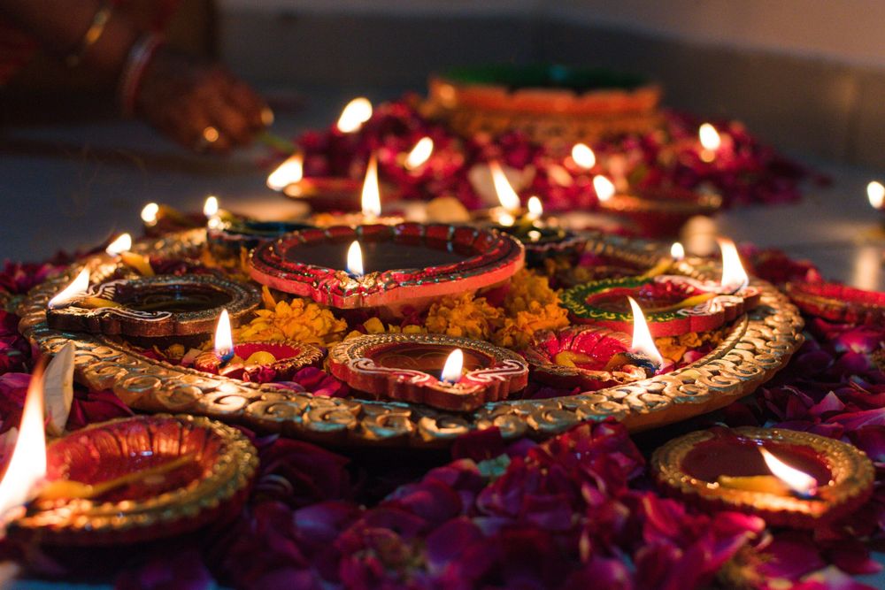 Beautiful combination of diyas and candles layed out beautifully for Diwali.