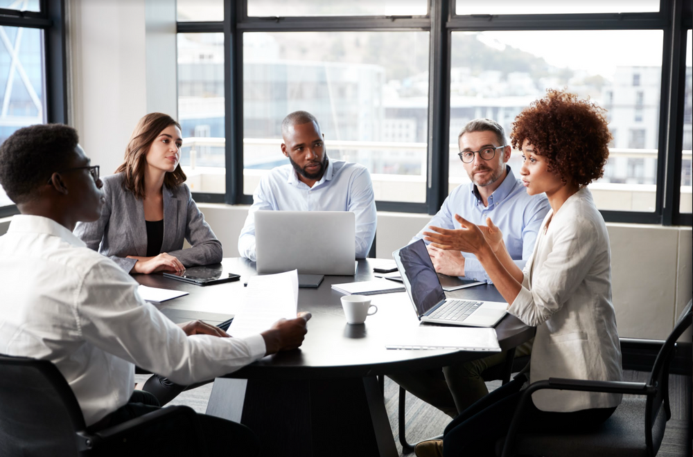 Stock image of diverse colleagues meeting in a conference room