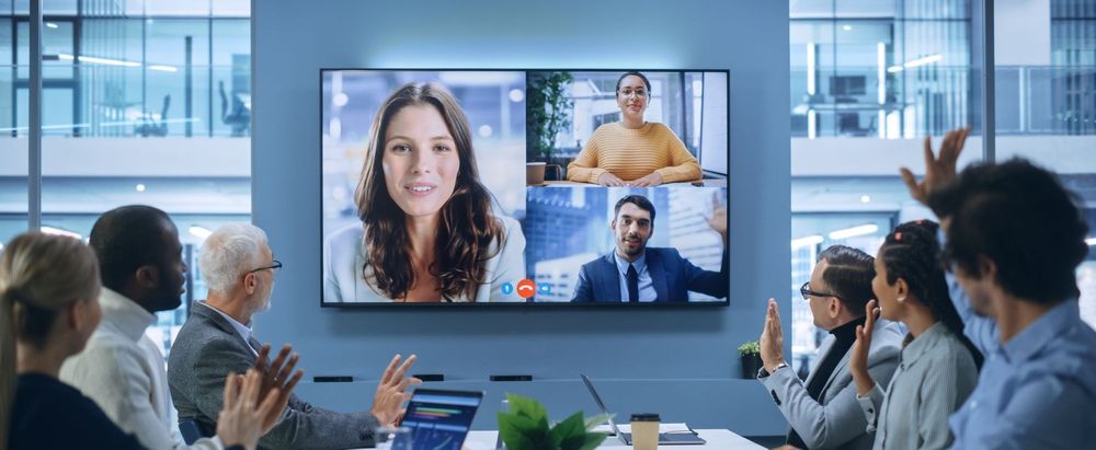 Remote meeting of business executives waving goodbye at the end of a video call