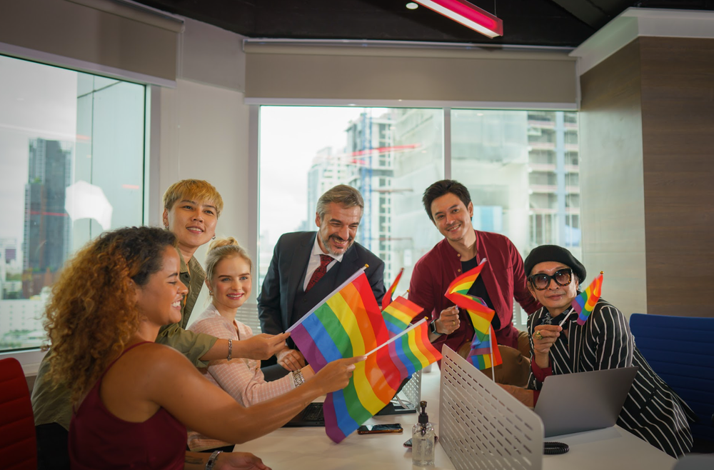 Business people holding pride flags stock photo