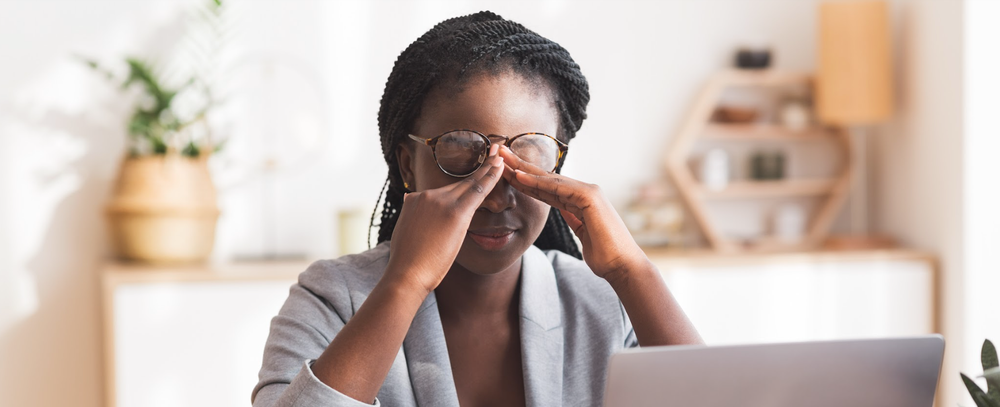 Black woman rubbing forehead