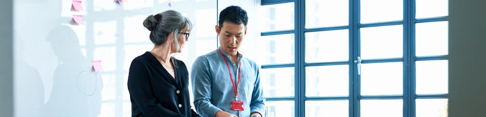 Two people planning inclusive onboarding in the office