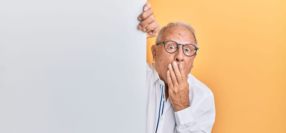 Man covering his mouth in shock