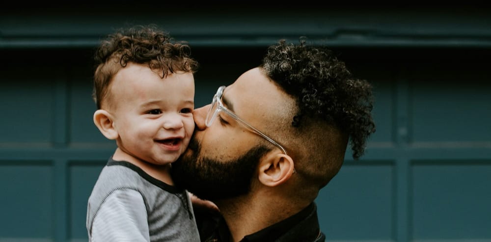 A parent holds a toddler