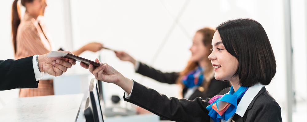 Airline employee checking passengers into flight