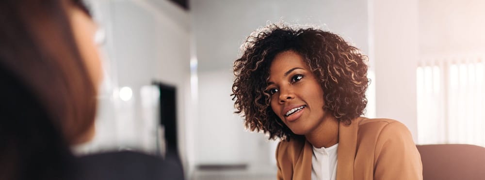 Young woman doing a job interview in the office and talking with client