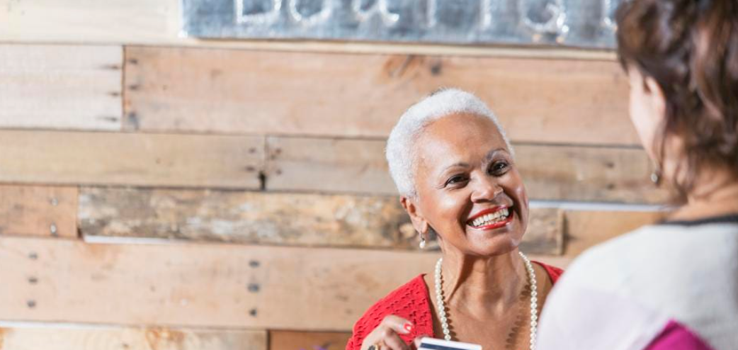 Older Black woman paying for a gift