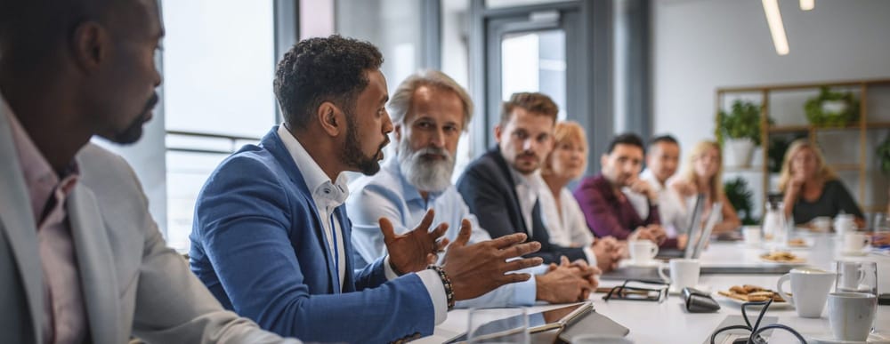 Team of primarily men at a boardroom table