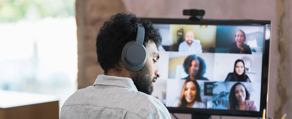 Man of Indian descent joins a video call with a diverse team