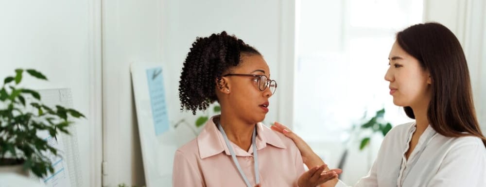 Woman consoling her colleague at the office