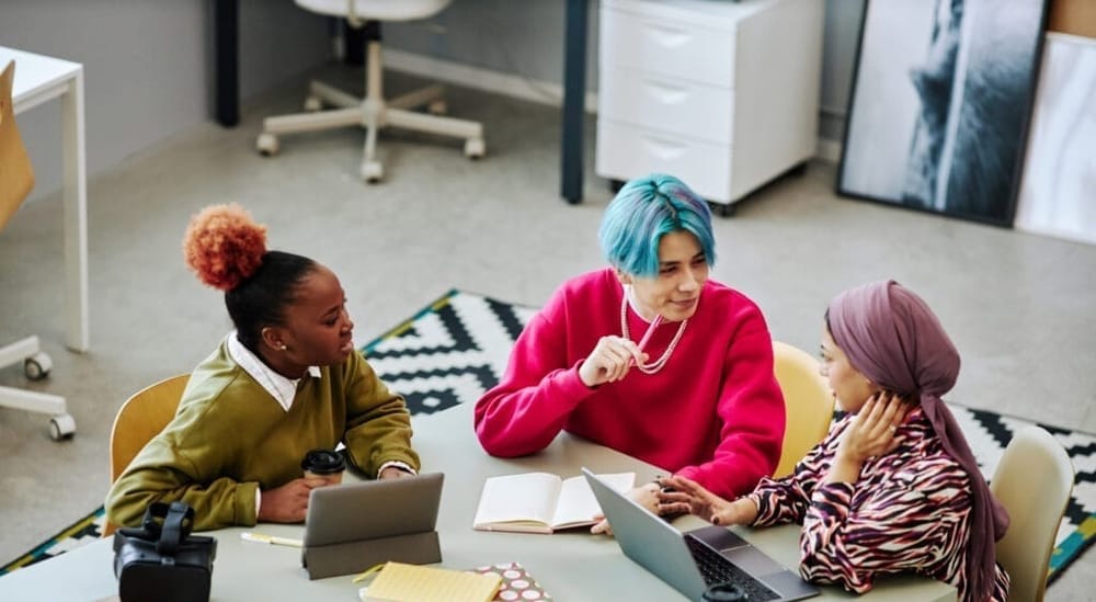 A team of young professionals meet in an office